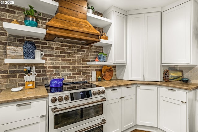 3045 SW Gaston Ave, Portland, OR 97239 - kitchen with open shelves, electric range oven, white cabinets, and decorative backsplash
