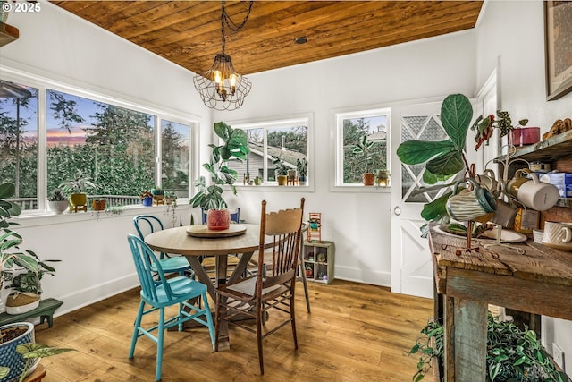 3045 SW Gaston Ave, Portland, OR 97239 - dining area with hardwood / wood-style flooring, wooden ceiling, a chandelier, and baseboards