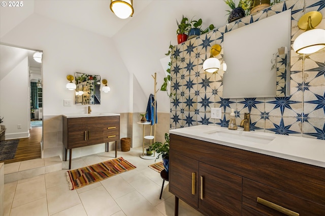 3045 SW Gaston Ave, Portland, OR 97239 - full bathroom featuring vanity, tile patterned floors, lofted ceiling, and tasteful backsplash