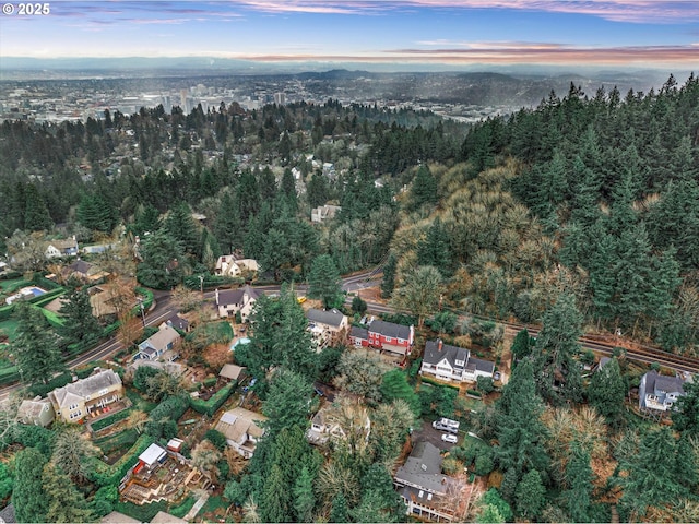 birds eye view of property featuring a forest view