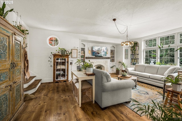 3045 SW Gaston Ave, Portland, OR 97239 - living room with dark wood finished floors, a chandelier, a textured ceiling, and a fireplace