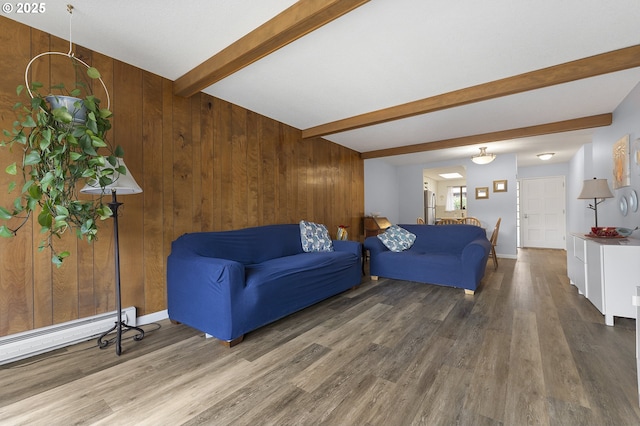 living room with wood finished floors, beamed ceiling, wooden walls, a baseboard heating unit, and baseboards