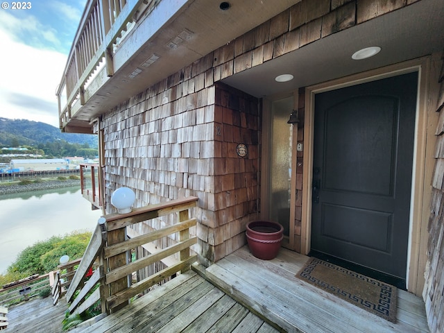 doorway to property featuring a balcony and a water view