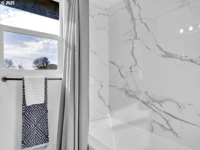 interior details featuring shower / bath combination with curtain