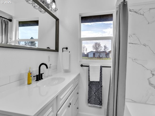 bathroom featuring vanity and shower / tub combo