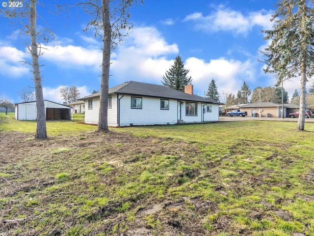 rear view of property with a yard