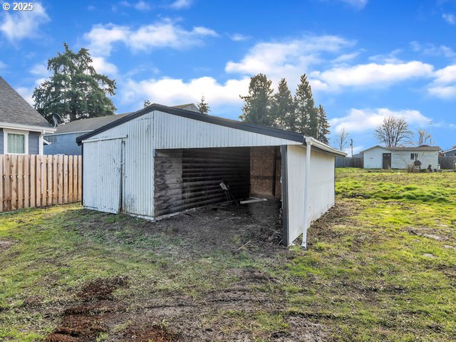 view of outbuilding featuring a yard