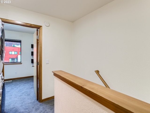 corridor featuring dark colored carpet