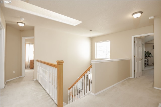 16713 NW Countryridge Dr, Portland, OR 97229 - hall featuring an upstairs landing, a skylight, and carpet flooring