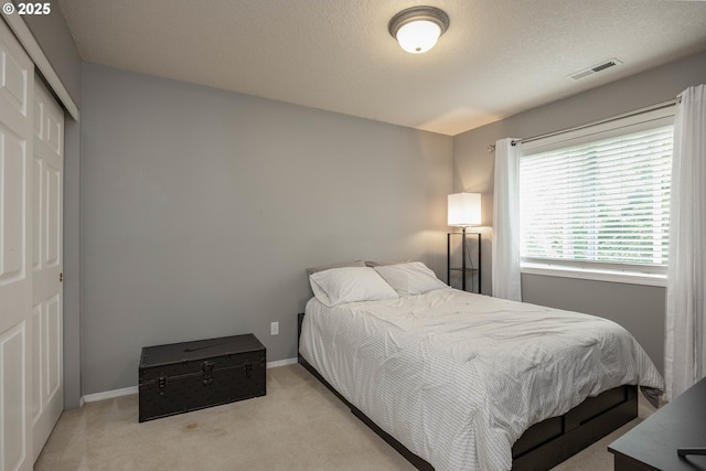 16713 NW Countryridge Dr, Portland, OR 97229 - carpeted bedroom with a closet and a textured ceiling