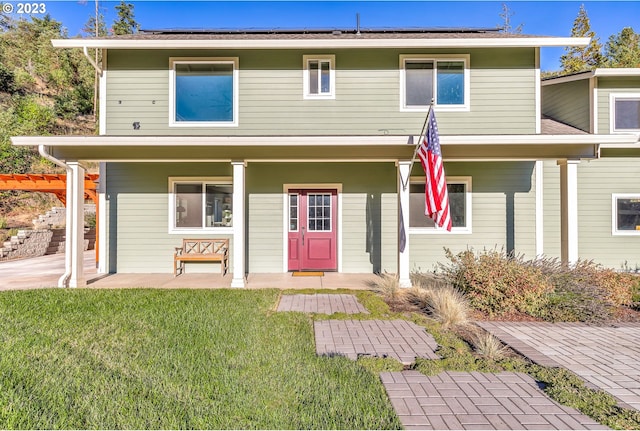 view of front facade with a front yard and a porch