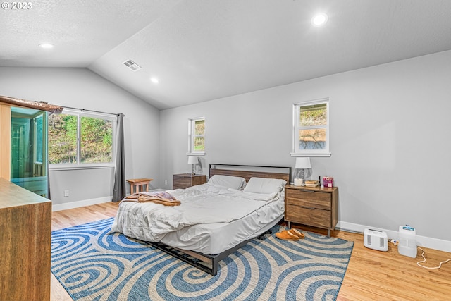 bedroom featuring vaulted ceiling and light hardwood / wood-style flooring