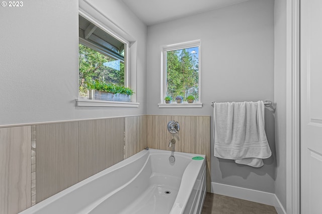 bathroom featuring a bathtub and tile floors