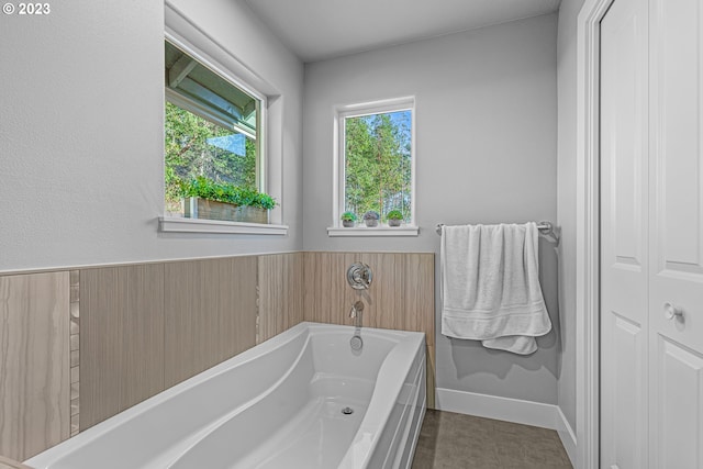 bathroom featuring a bath and tile flooring