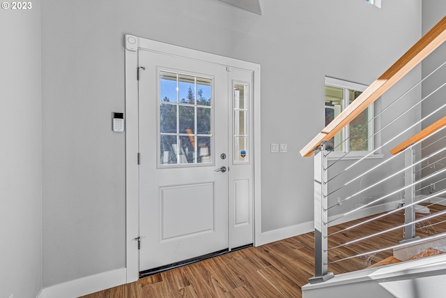 foyer entrance with dark hardwood / wood-style floors