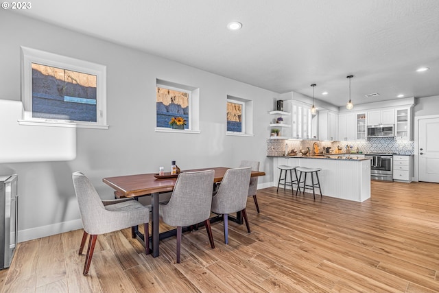 dining area with light hardwood / wood-style flooring