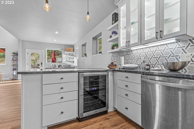 kitchen with wine cooler, white cabinetry, dishwasher, and pendant lighting