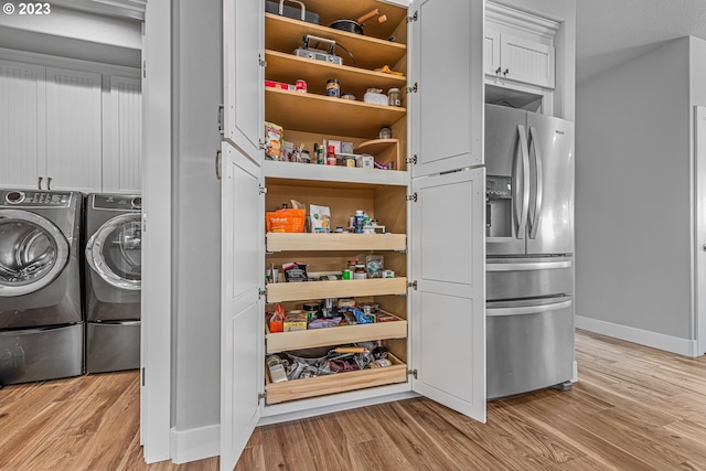 pantry featuring independent washer and dryer