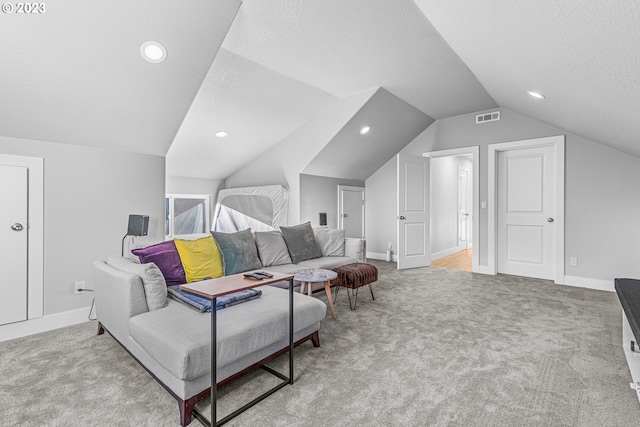 interior space featuring light carpet, a textured ceiling, and vaulted ceiling