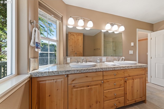 bathroom with dual bowl vanity and tile flooring