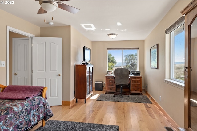 office with ceiling fan and light wood-type flooring