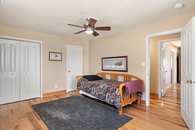 bedroom with light hardwood / wood-style floors, a closet, and ceiling fan