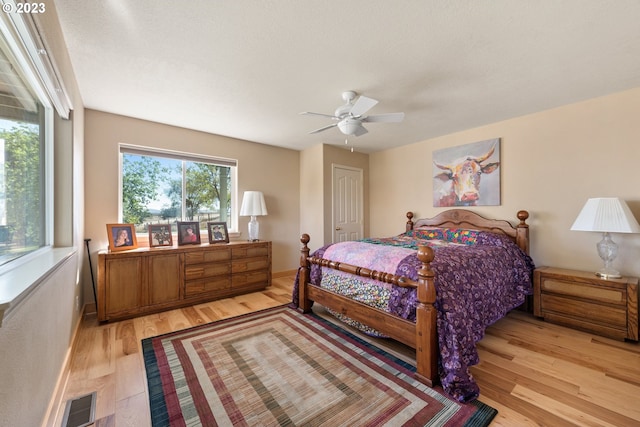 bedroom featuring a closet, ceiling fan, and light wood-type flooring