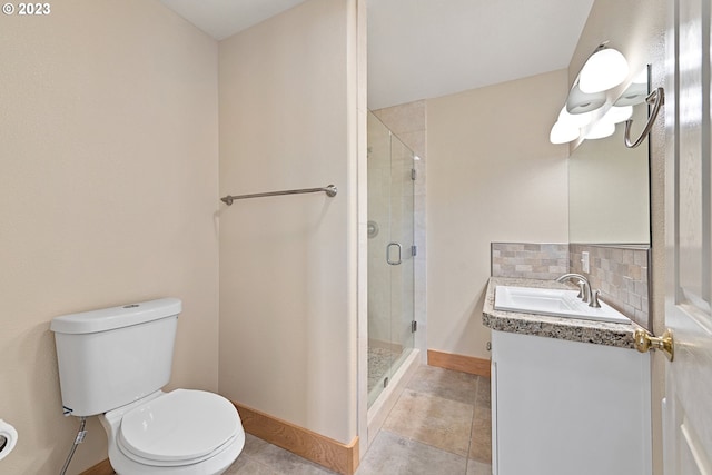 bathroom featuring toilet, a shower with door, vanity, tasteful backsplash, and tile floors