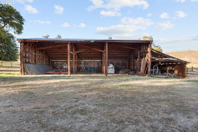 rear view of property featuring a lawn and an outdoor structure