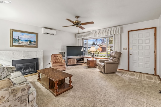 living room featuring baseboards, a ceiling fan, carpet, a fireplace, and a wall mounted AC