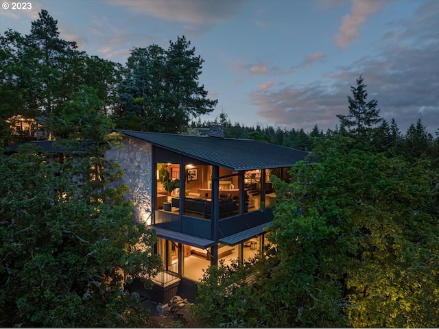 property exterior at dusk with a balcony