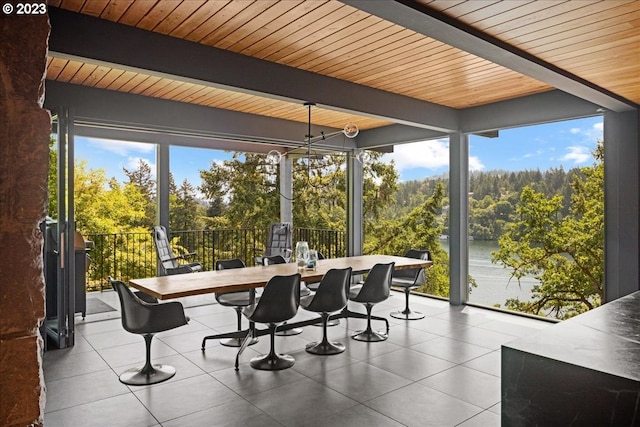 sunroom / solarium featuring wooden ceiling, a notable chandelier, and beam ceiling