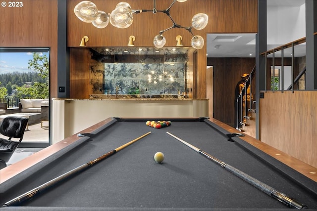 playroom with wood walls and billiards