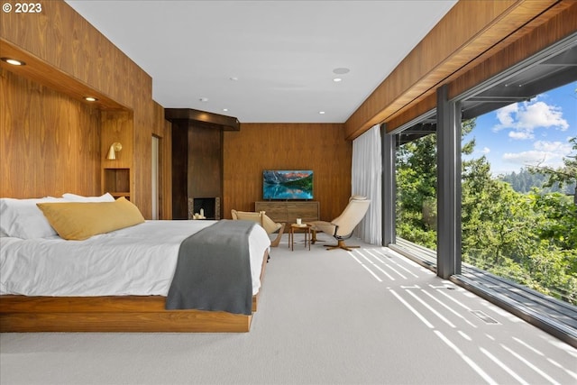 carpeted bedroom with wood walls