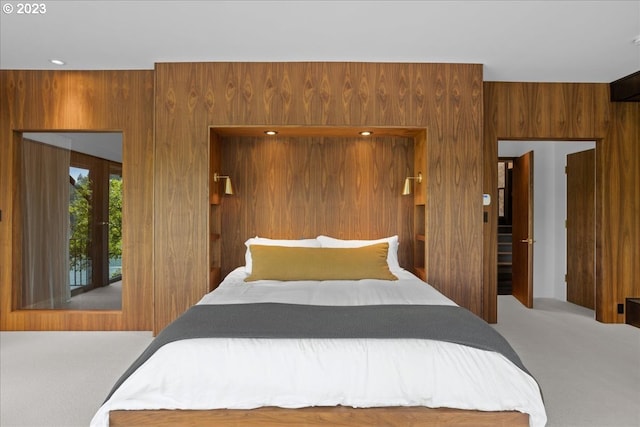 bedroom with wooden walls and carpet flooring