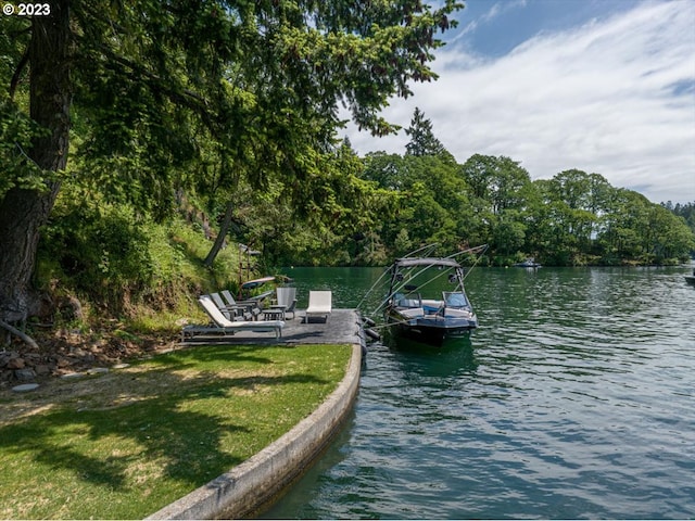 view of dock with a water view and a yard