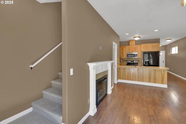 2622 Princeton Pl, Forest Grove, OR 97116 - kitchen featuring appliances with stainless steel finishes, light brown cabinetry, a peninsula, baseboards, and dark wood-style flooring
