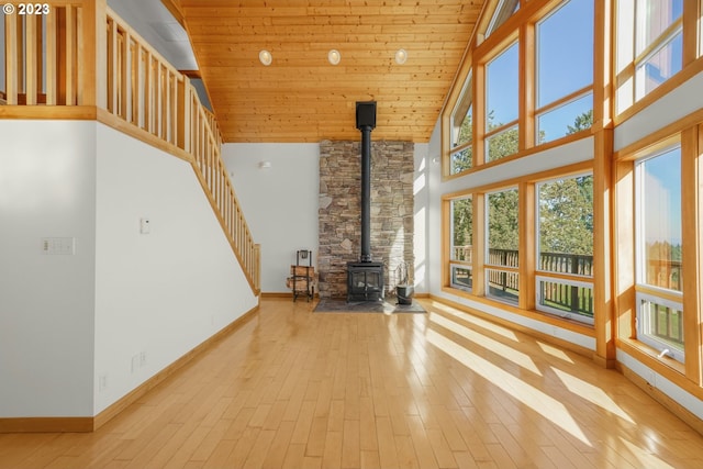 22000 SE Upper Matthews Creek Ln, Amity, OR 97101 - unfurnished living room with wood ceiling, a wood stove, high vaulted ceiling, and light hardwood / wood-style floors