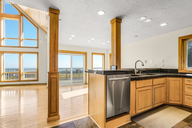 22000 SE Upper Matthews Creek Ln, Amity, OR 97101 - kitchen with stainless steel dishwasher, kitchen peninsula, light wood-type flooring, sink, and decorative columns