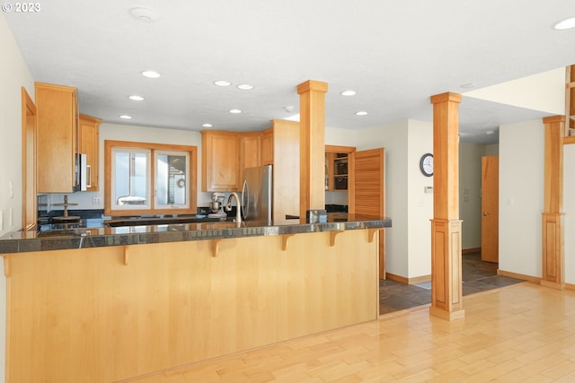 22000 SE Upper Matthews Creek Ln, Amity, OR 97101 - kitchen featuring a kitchen bar, light hardwood / wood-style flooring, kitchen peninsula, and ornate columns