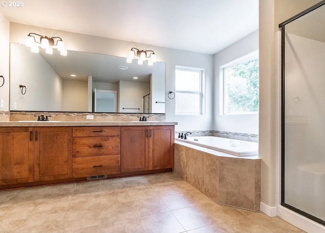 full bath with a stall shower, a garden tub, double vanity, and tile patterned floors