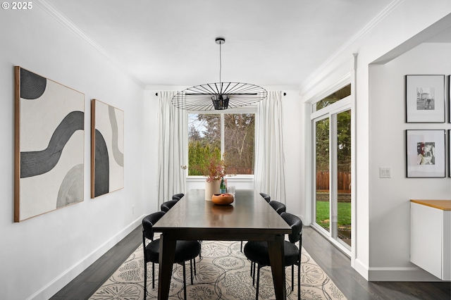 dining room with ornamental molding, dark wood-type flooring, and a healthy amount of sunlight