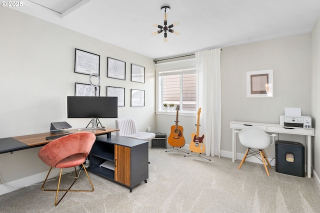 office space with baseboards, an inviting chandelier, and light colored carpet