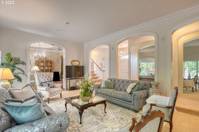 living room with ornamental molding, a chandelier, and light carpet