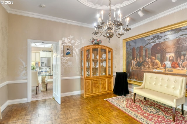 sitting room featuring crown molding, rail lighting, an inviting chandelier, and light parquet floors