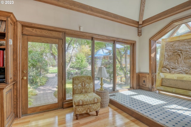 entryway featuring lofted ceiling with beams and light hardwood / wood-style floors