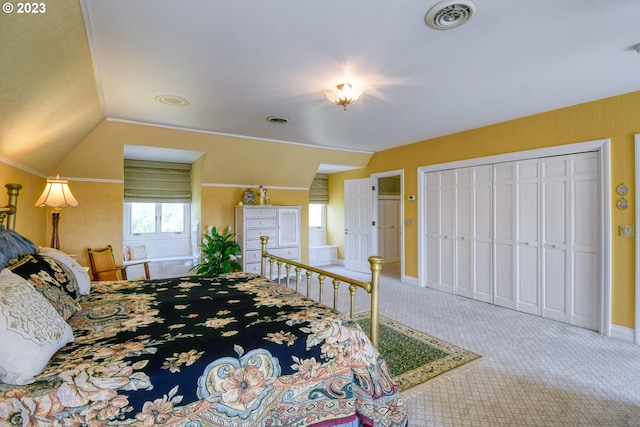 carpeted bedroom featuring a closet and lofted ceiling