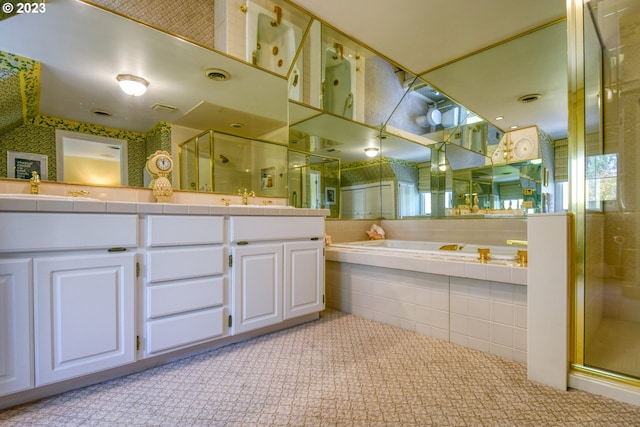 bathroom with shower with separate bathtub, tile floors, and vanity