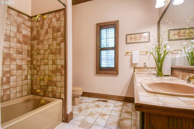 full bathroom with tiled shower / bath combo, toilet, large vanity, and tile flooring