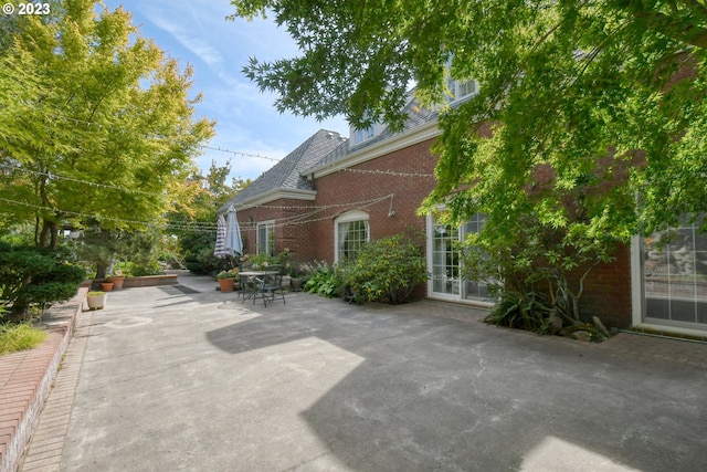 view of side of property with a patio